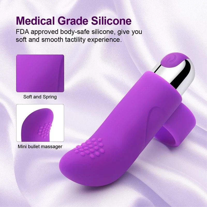 Purple medical grade silicone mini bullet massager with soft textured tip, displayed with product feature callouts on white fabric background